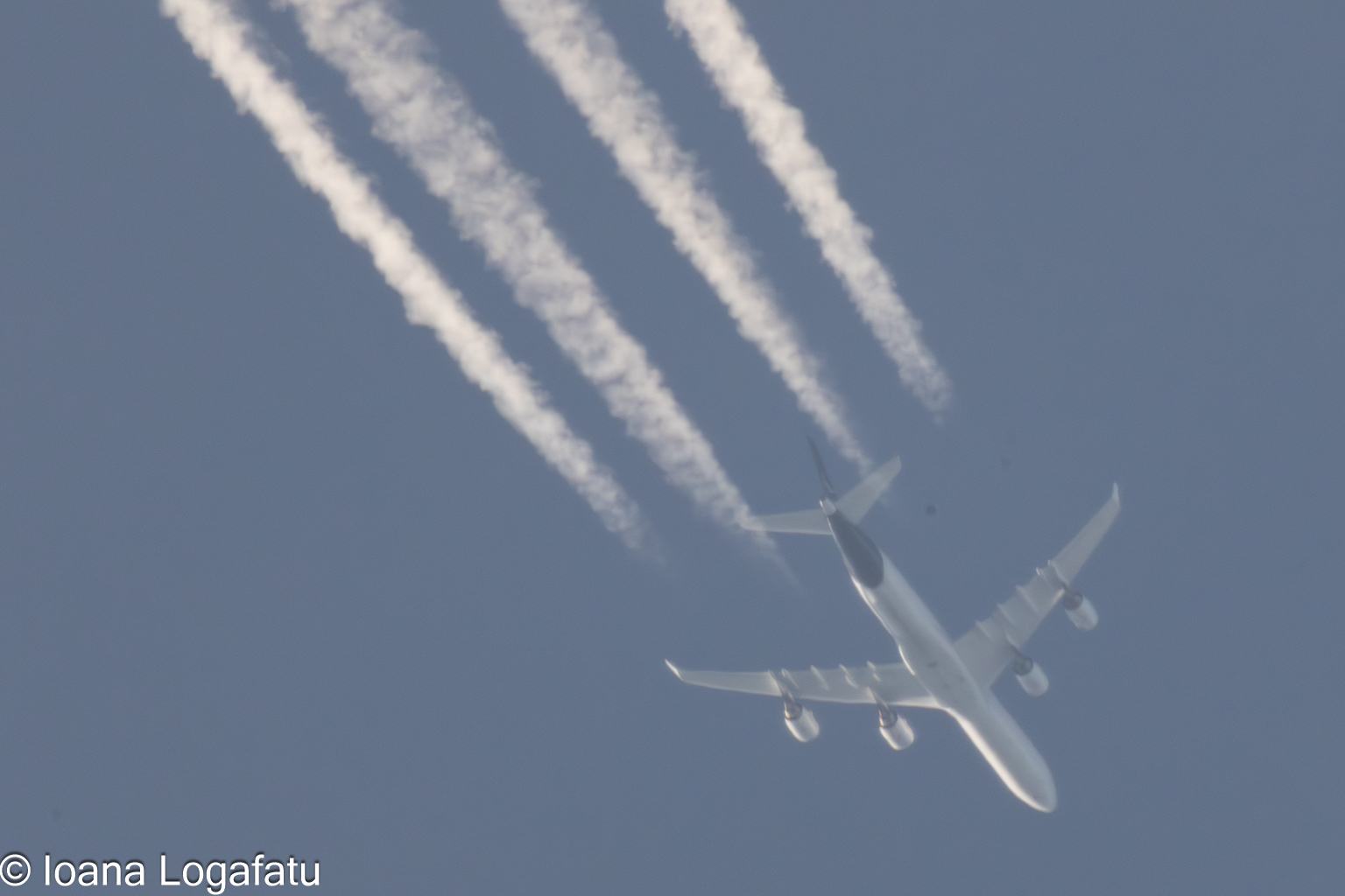 High above the clouds, an airplane journeys onward